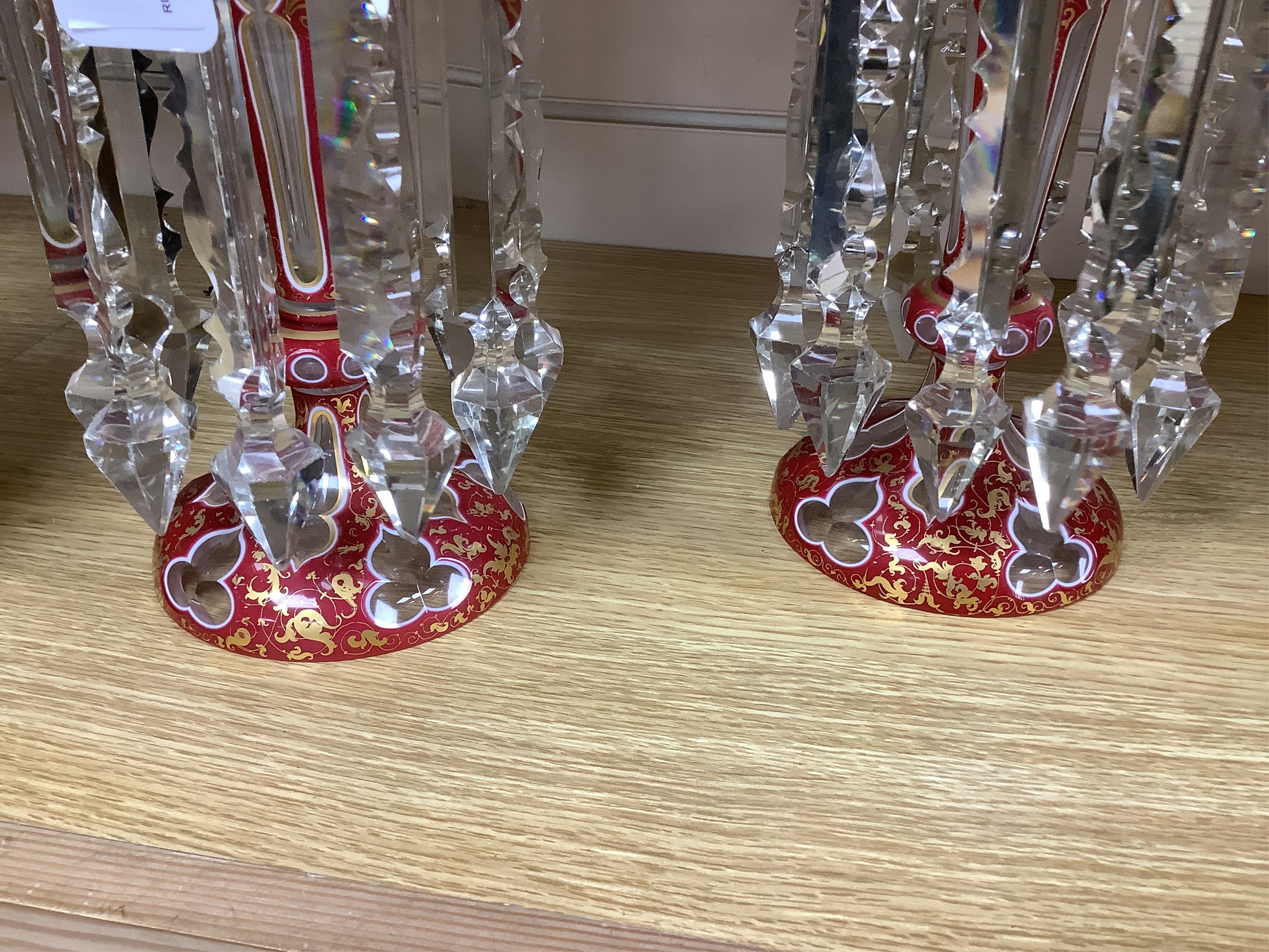 A pair of Bohemian ruby-overlaid table lustres, 26cm high. Condition - some chipping to the glass lustre drops